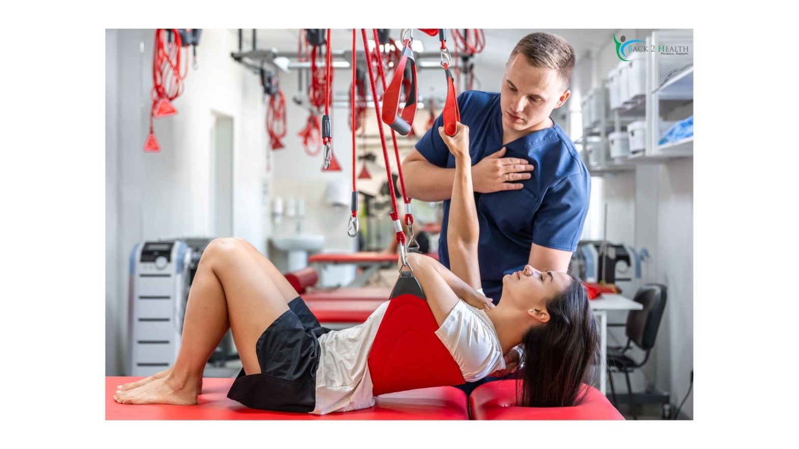 A therapist guiding a patient through suspension-based rehabilitation exercises during an Auto Accident Physical Therapy session in a clinical treatment room.