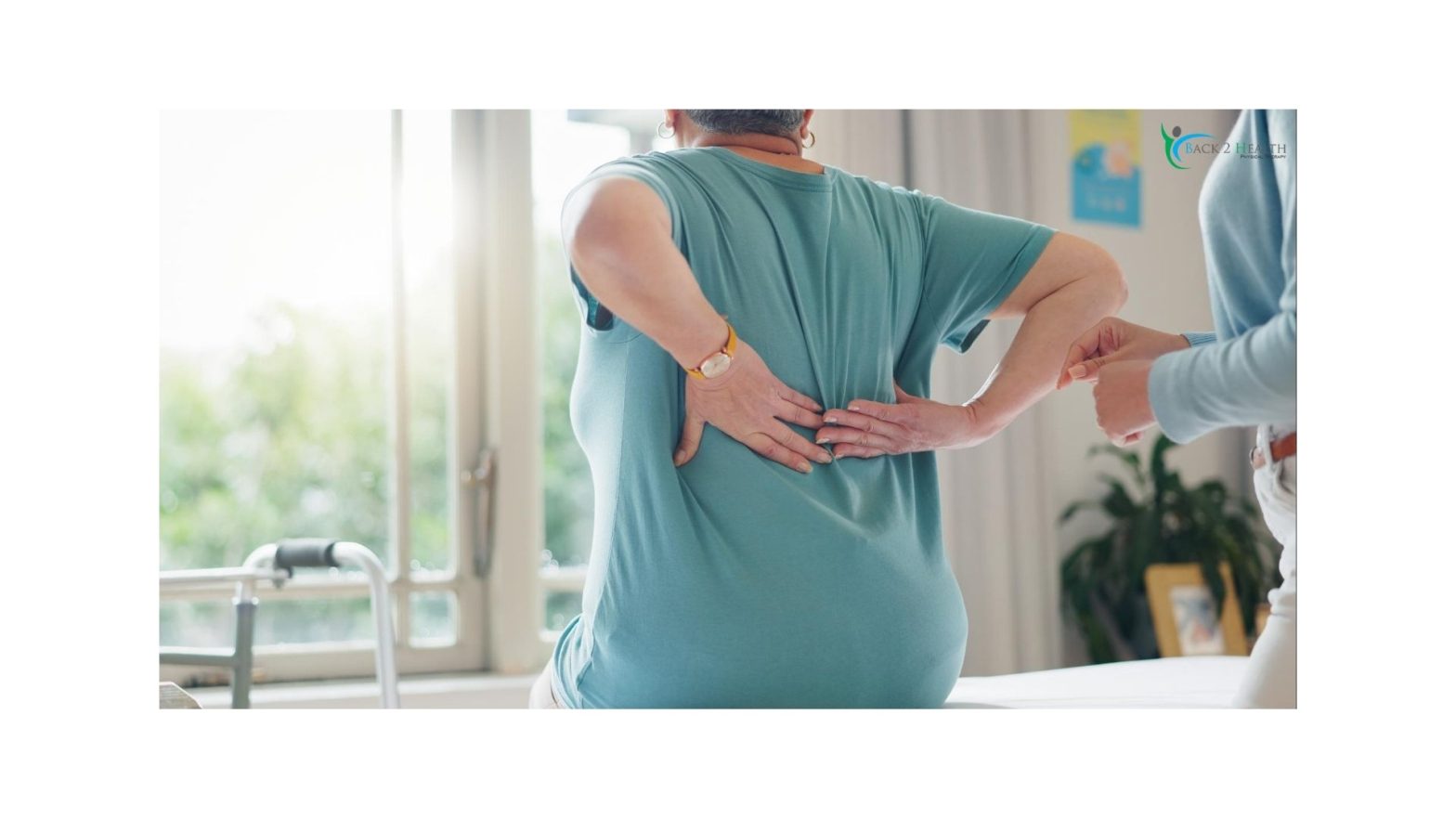 Patient experiencing lower back pain during physical therapy session, with therapist guidance at Back 2 Health clinic.