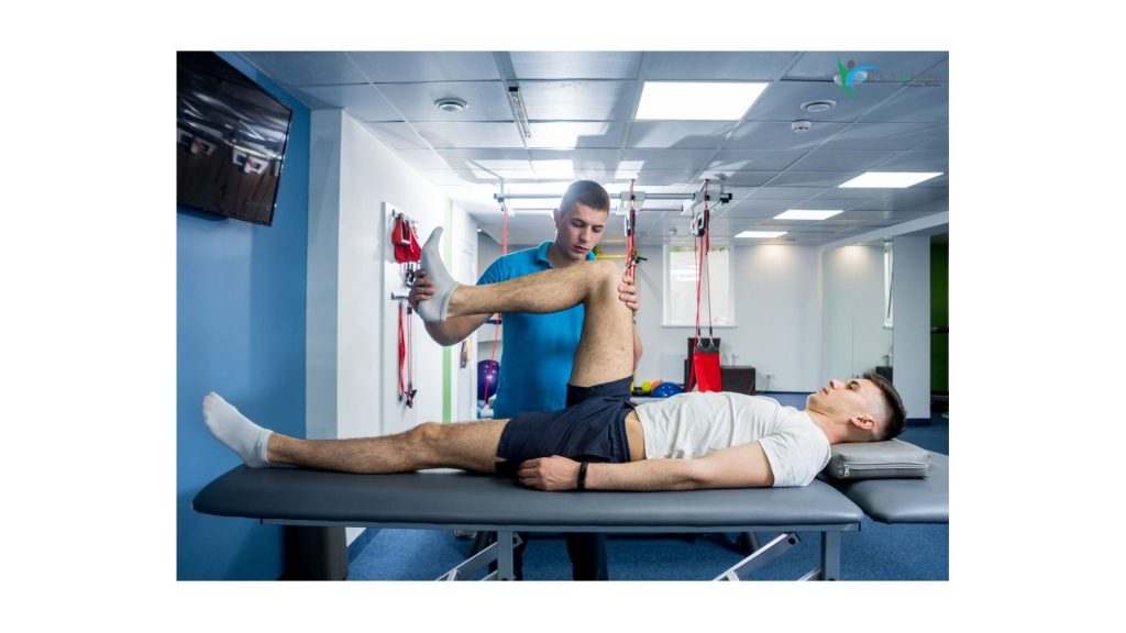 Physical therapist assisting a patient with leg mobility exercises during accident injury rehabilitation in a physical therapy clinic.