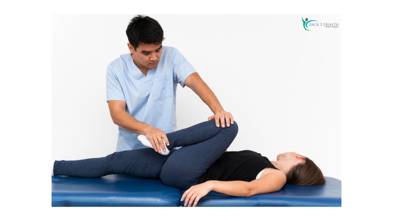 A physical therapist at Back 2 Health performing assisted knee replacement rehab exercises on a patient to improve joint mobility and flexibility.
