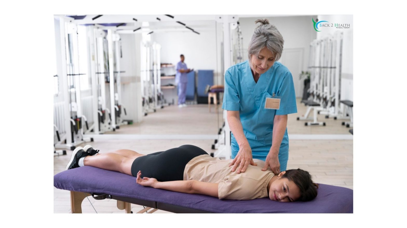 A physical therapist providing hands-on manual back therapy to a patient on a treatment table at the Back 2 Health clinic.