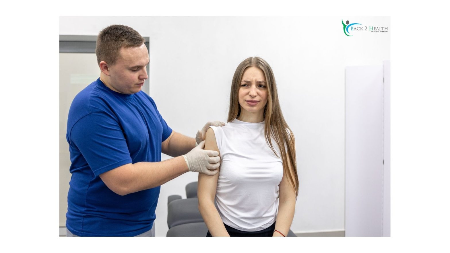 A specialist at Back 2 Health evaluating a patient's shoulder to develop a plan for rotator cuff rehab exercises.