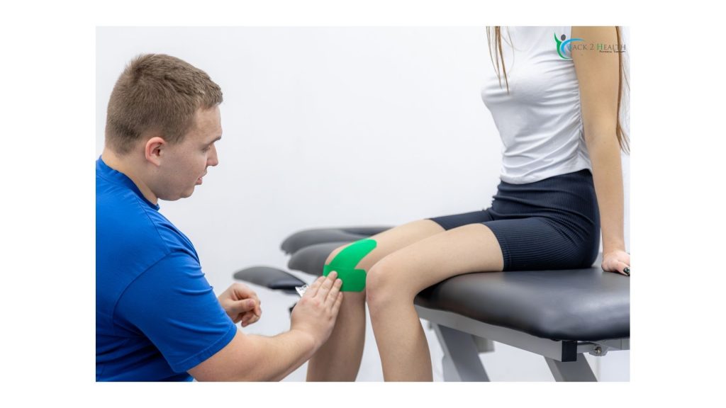 A physical therapist applying bright green kinesiology tape to a female patient's knee during a rehabilitation session.