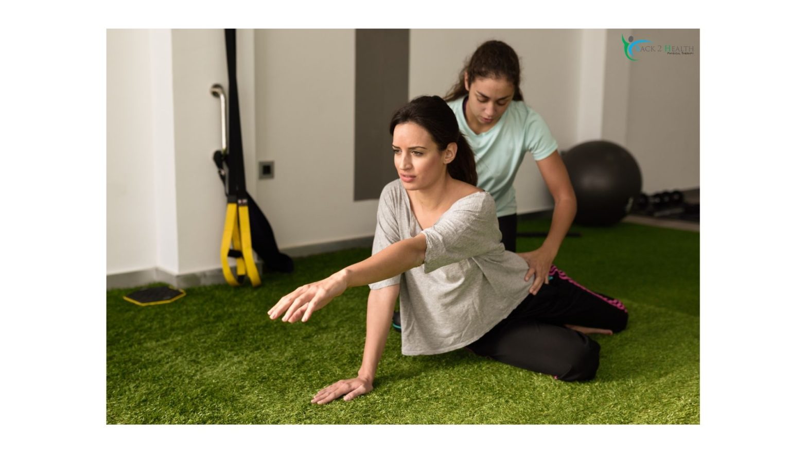 A female therapist guiding a patient through a rehabilitation stretch at Back 2 Health, demonstrating professional physical therapy services in Brownstown.
