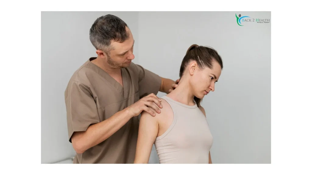 Physical therapist assessing upper back and shoulder alignment during physical therapy for upper back pain.