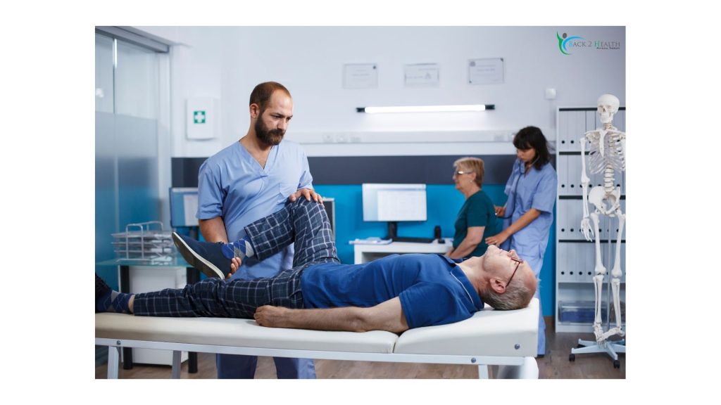 Physical therapist performing leg mobility stretch on a patient during auto accident physical therapy session in clinic.