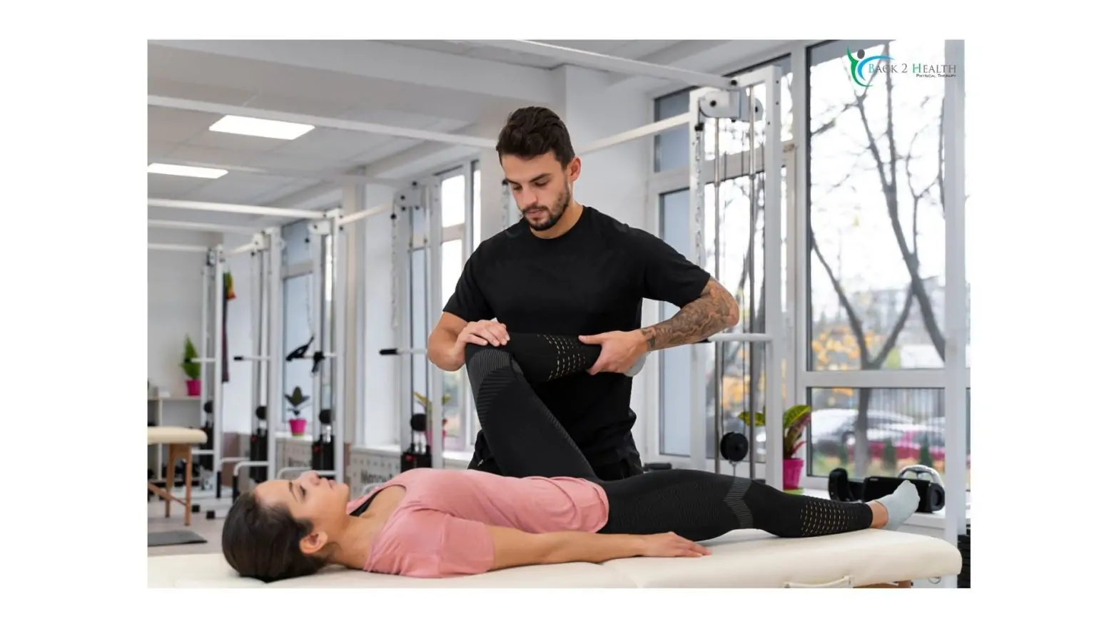 A physical therapist stretching a patient's leg during physical therapy in Sterling Heights at the Back 2 Health clinic.