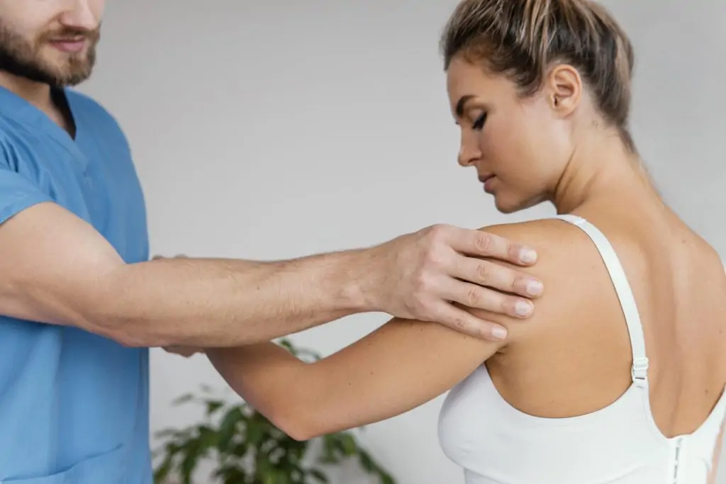Physical therapist assessing a patient's shoulder for shoulder pain